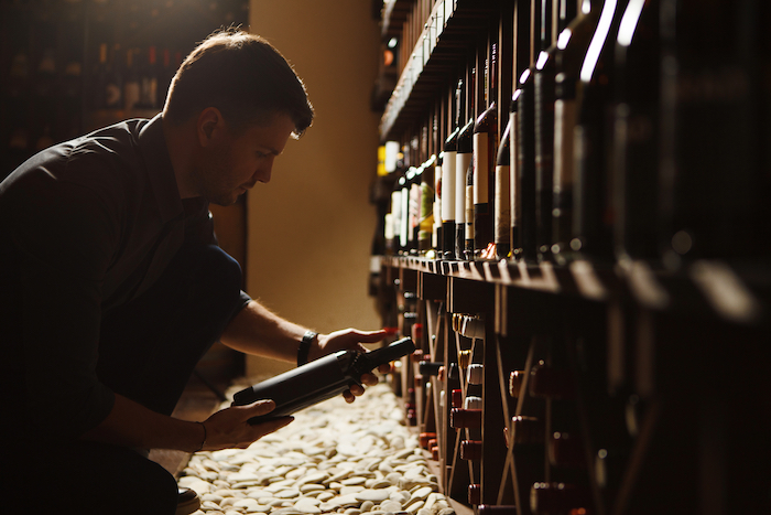 sommelier selecting a bottle of wine